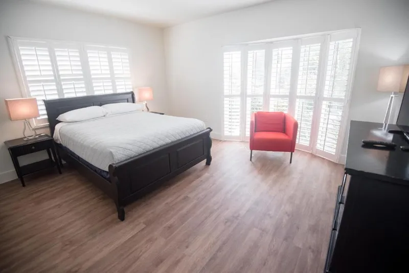 White wooden plantation shutters on a bay window in a guest room
